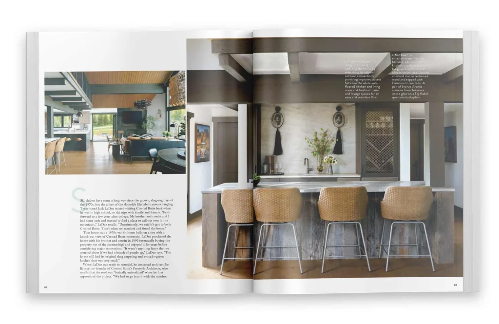 Magazine feature showing an open-concept kitchen and bar designed by Freestyle Architects in a modern chalet renovation, with rustic beams, woven barstools, and mountain views in Mount Crested Butte, Colorado.