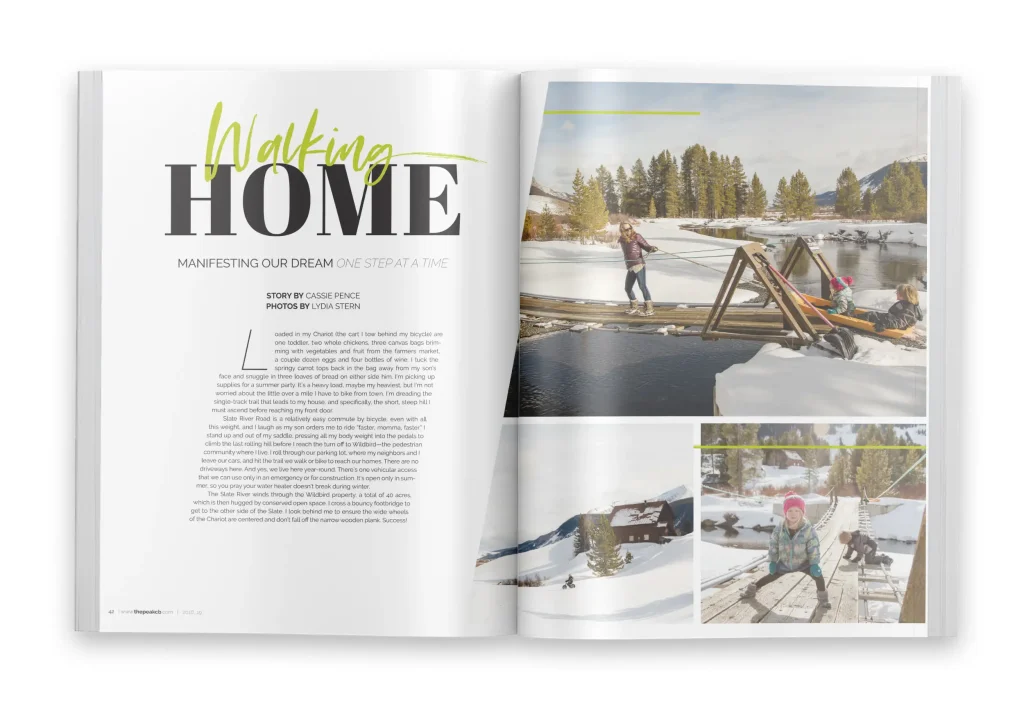 Magazine spread titled “Walking Home” showing a snowy mountain scene with a woman pulling a child across a wooden footbridge, and a colorful winter setting with a cabin and children playing in the snow.