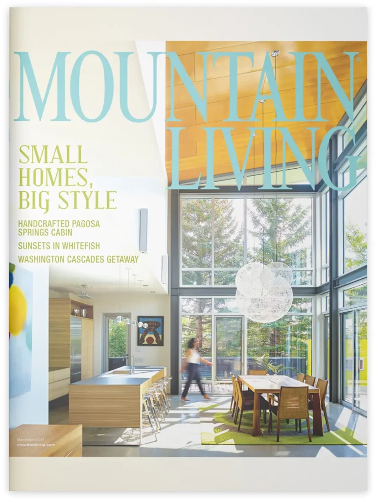 Magazine cover of Mountain Living showcasing a bright, modern mountain kitchen and dining space with full-height windows, wood accents, and clean architectural lines.