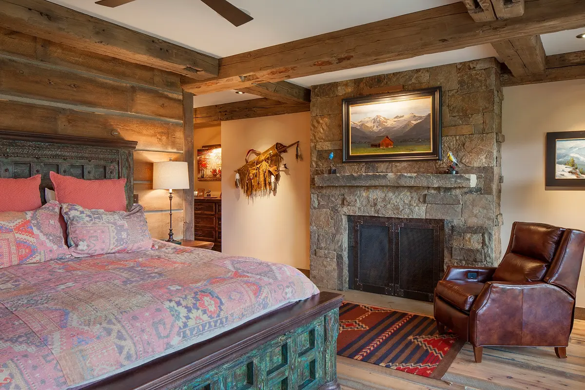 Open great room with vaulted timber ceiling spanning kitchen, living, and dining areas.