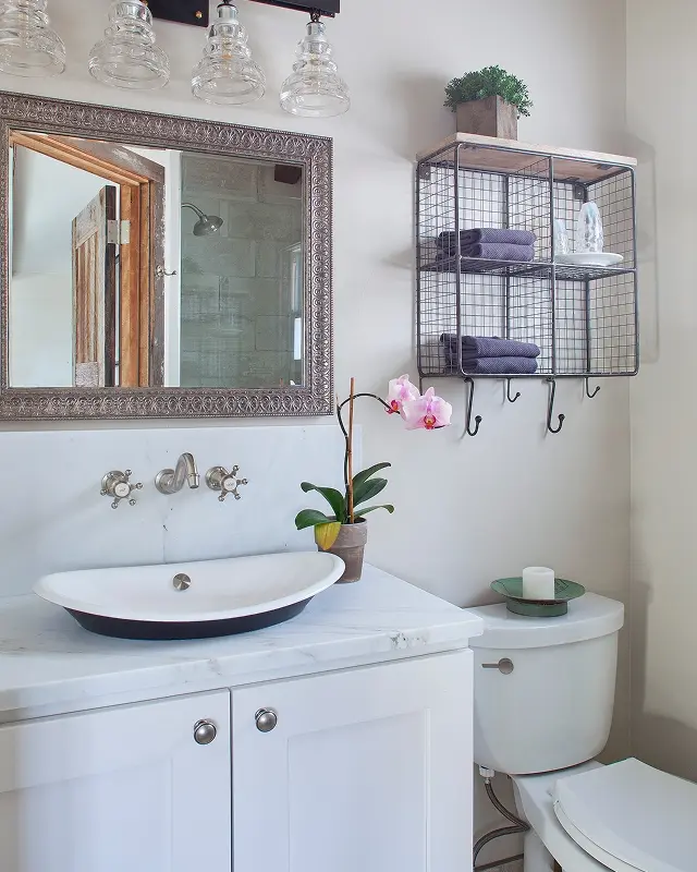 Stylish small bathroom in Crested Butte cabin with vessel sink and wire storage shelves.