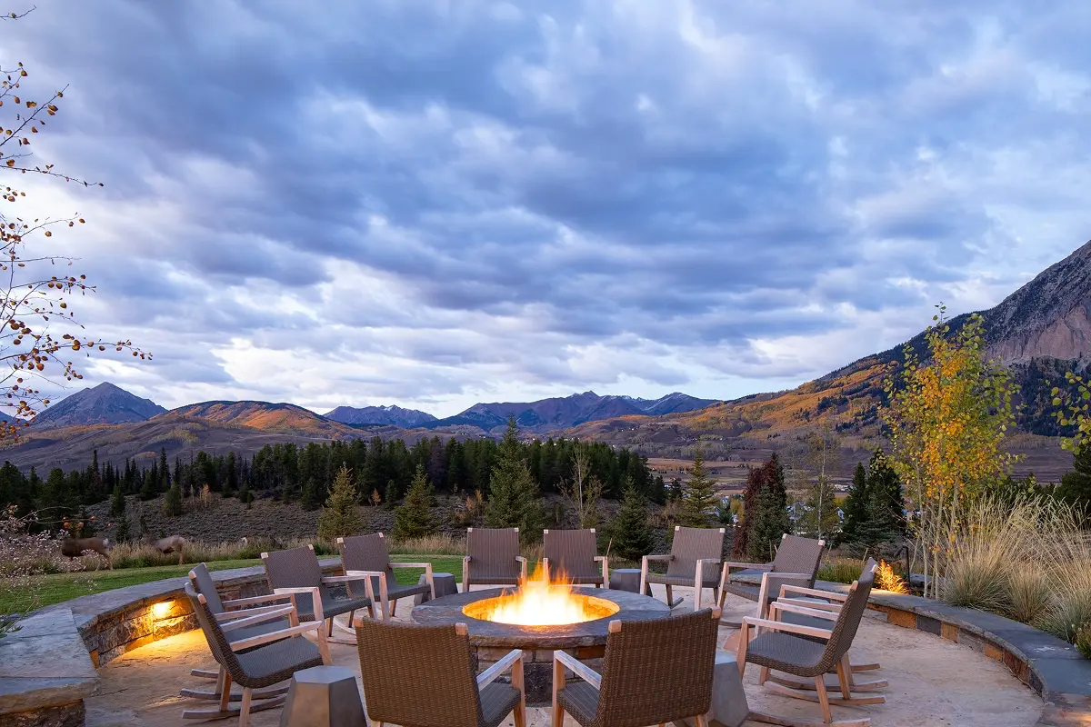 Sunset view from circular firepit patio overlooking the vast Crested Butte mountain range.