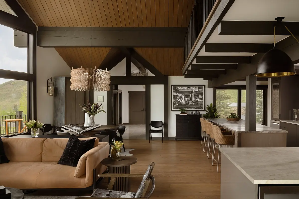 Open-concept dining area and kitchen featuring vaulted ceilings, wood accents, and mountain-inspired modern design.