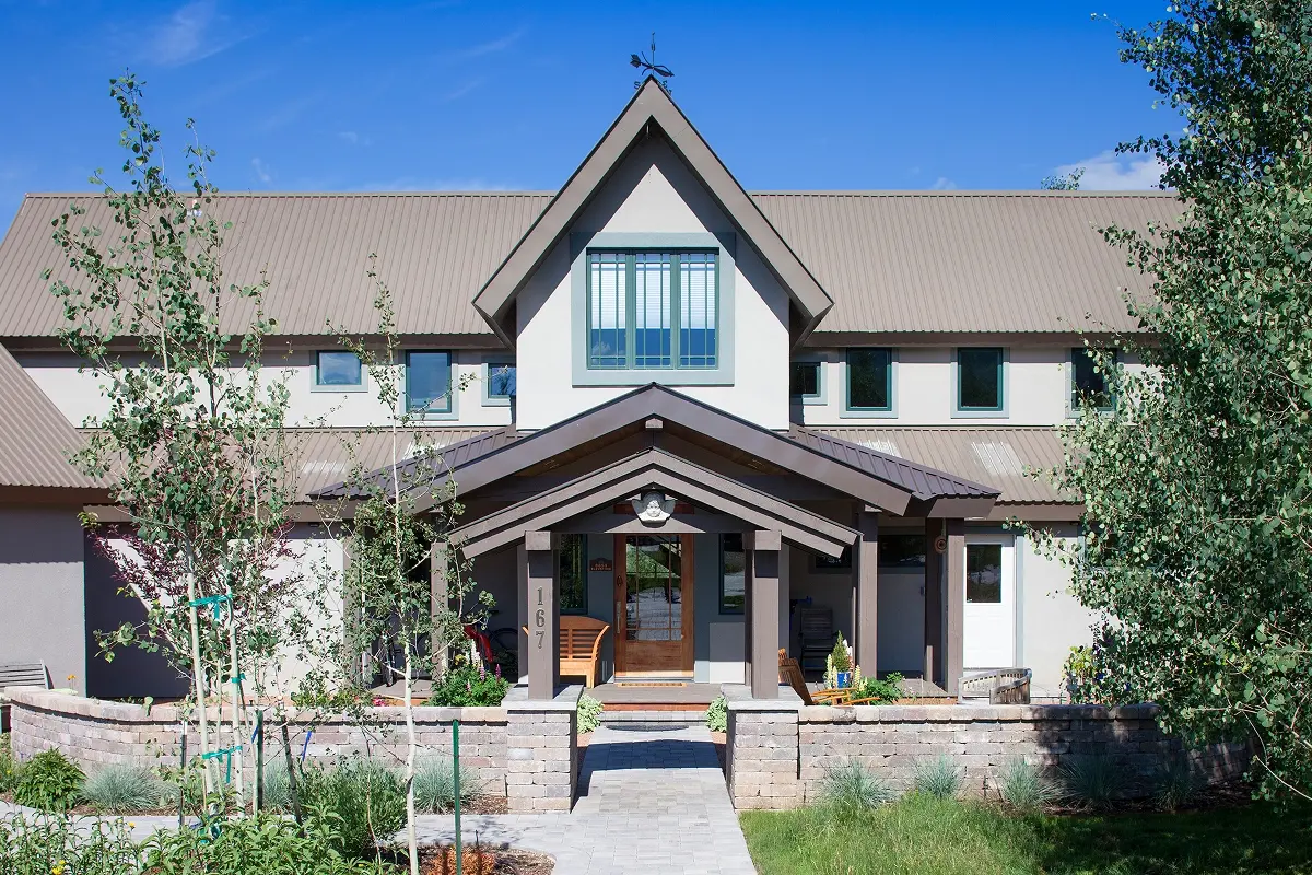 Updated front entry featuring a low-pitch hip roof, new color palette, and refreshed modern stucco finish.