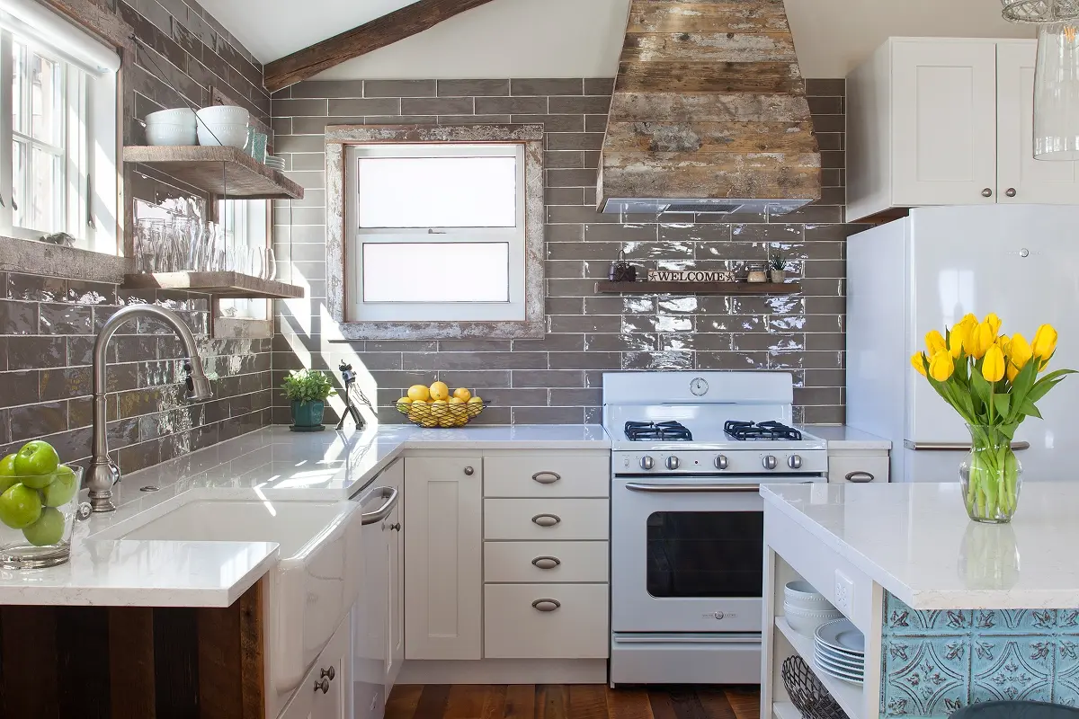 Rustic-modern kitchen with white cabinetry and wooden accents in historic Crested Butte cabin.