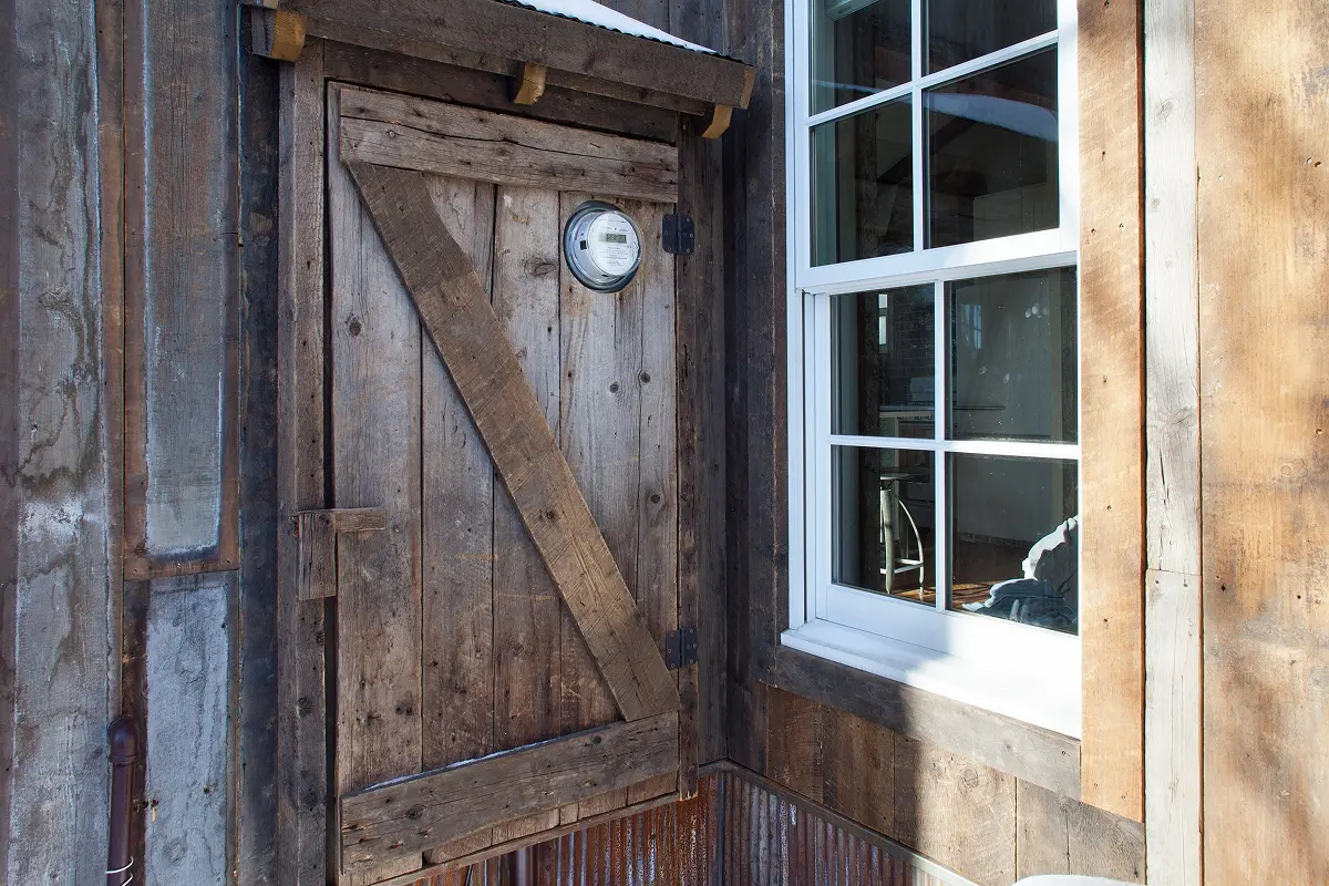 Close-up of rustic door and window detail on restored Crested Butte outbuilding.